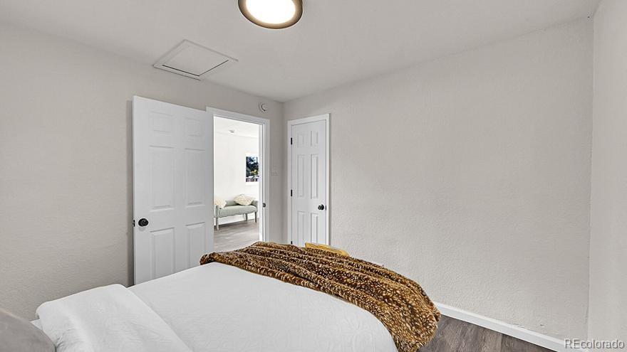 3984 Cook Street Denver, CO 80205 - Photo 8 of 34 a bedroom with a bed and a chandelier