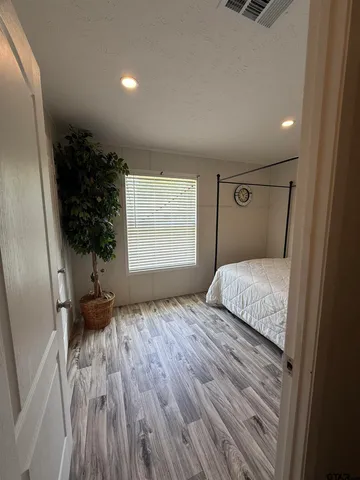 a bedroom with a bed and a couch