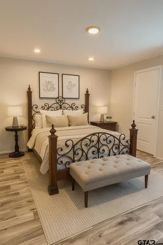 a view of a bedroom with a bed and lamp