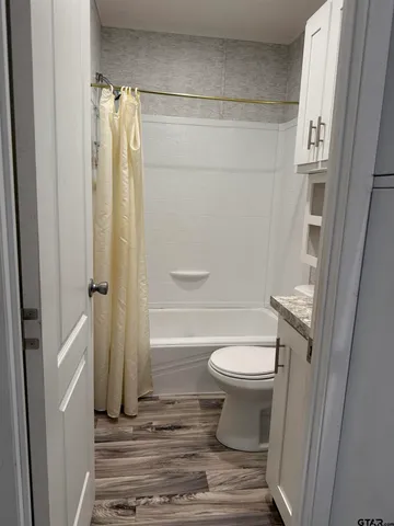 a bathroom with bathtub and a window