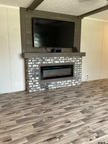 a living room with a flat screen tv and a fireplace