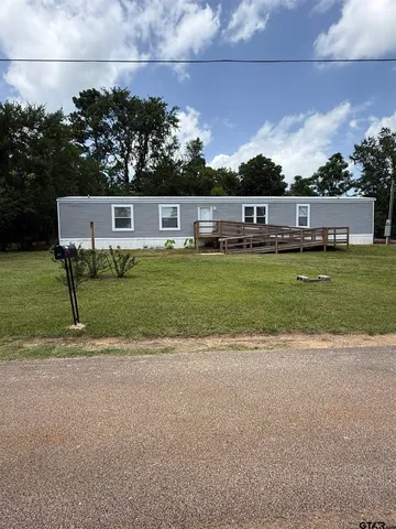 a view of a house with a backyard patio and swimming pool