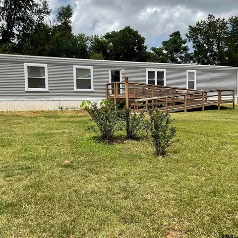 a view of a terrace with chairs and potted plants