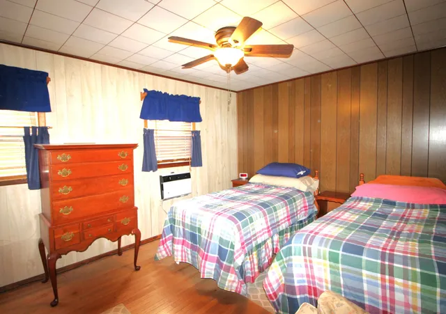 a bedroom with bed and a window