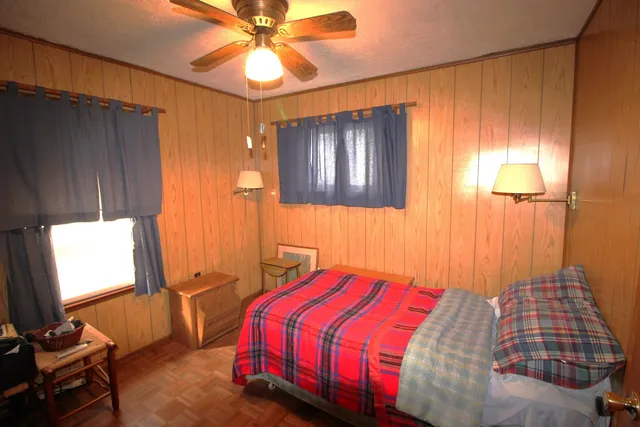 a bedroom with a bed and a chandelier