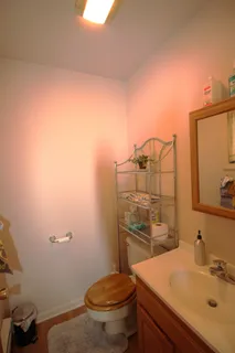 a bathroom with a sink a toilet and a mirror