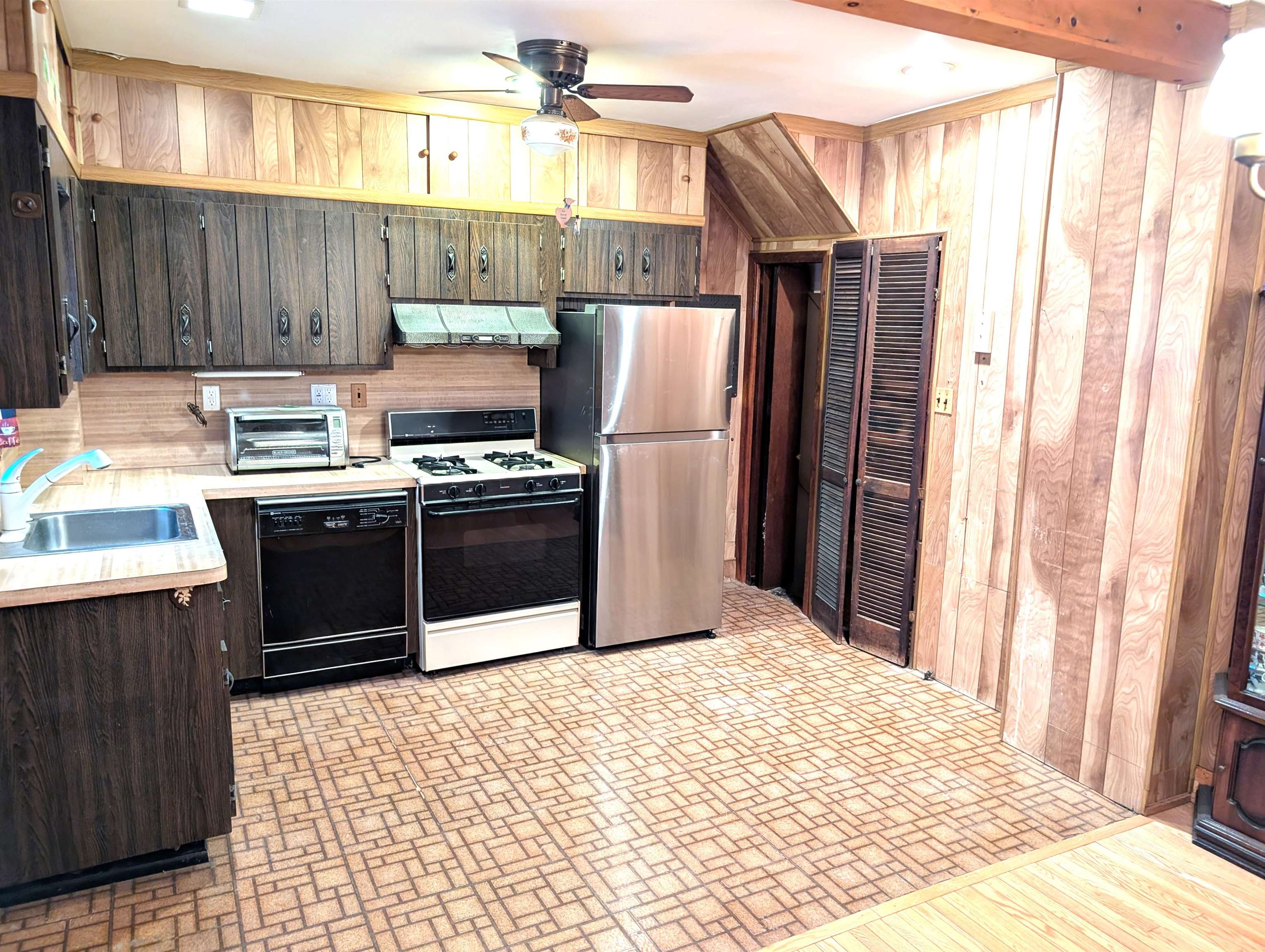 425 Davis Avenue Kearny, NJ 07032 - Photo 5 of 26 a kitchen with stainless steel appliances a stove a refrigerator and wooden cabinets