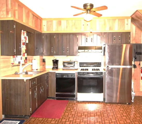 a kitchen with a sink cabinets and stainless steel appliances
