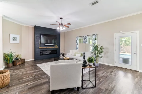 a view of a dining room with furniture a kitchen and chandelier