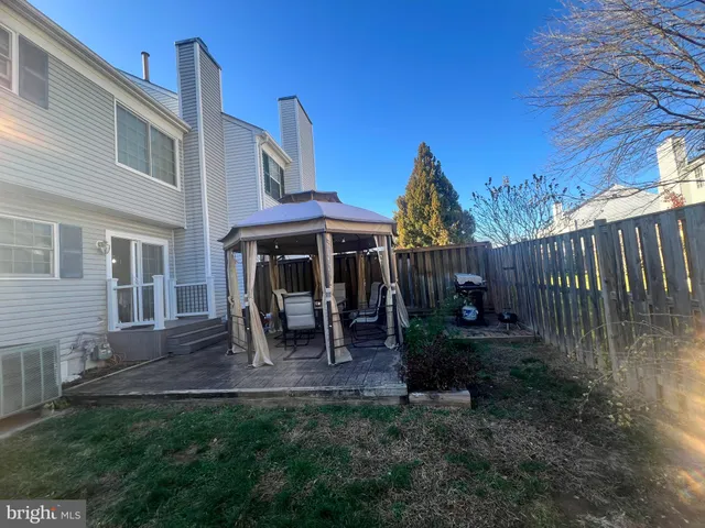 a view of house with a chairs in patio