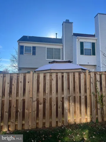 a view of a house with wooden fence