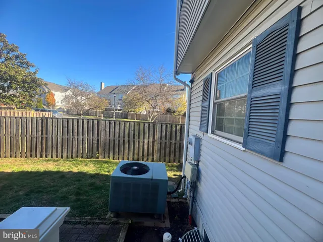 a view of a chair and table in backyard of the house