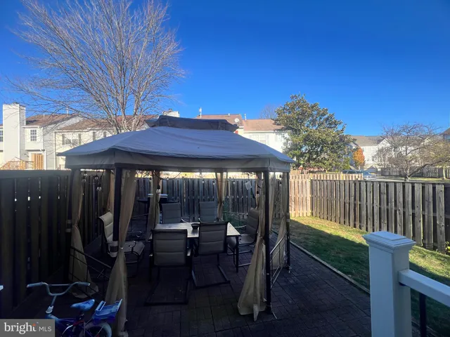a view of a patio with a table and chairs