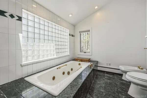 a bathroom with a tub and a window