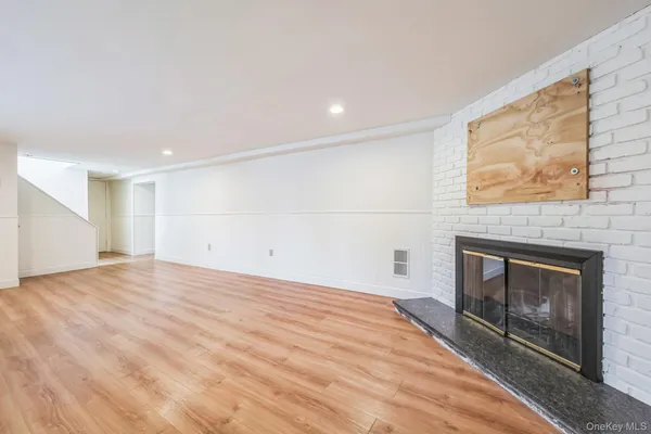 a view of empty room with a fireplace