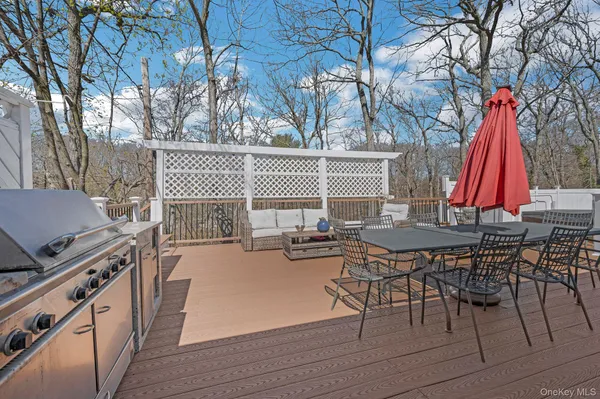 a view of empty room with wooden floor and fireplace
