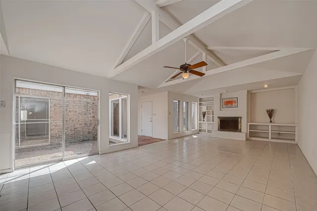 a view of a livingroom with an empty space and a fireplace