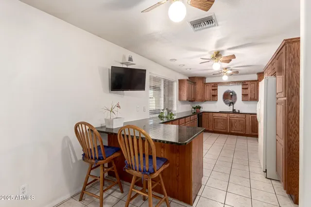 a view of a dining room with furniture and a flat screen tv