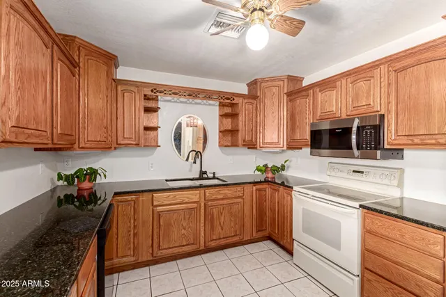 a kitchen with stainless steel appliances a sink cabinets and microwave