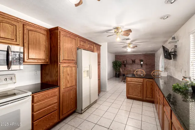 a kitchen with stainless steel appliances granite countertop a refrigerator and a sink