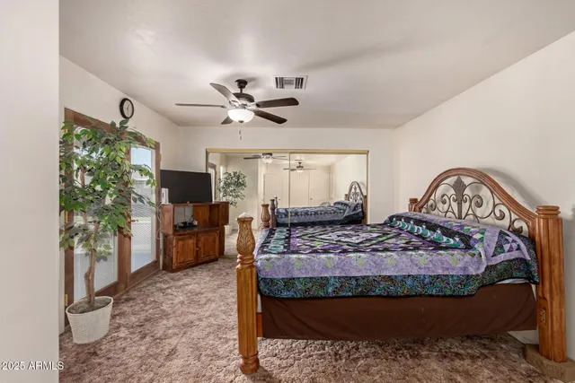 a bed room with furniture and a flat screen tv