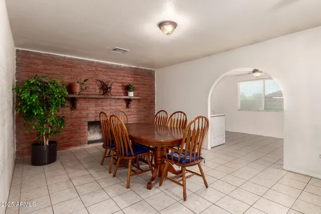 a dining room with furniture and potted plants