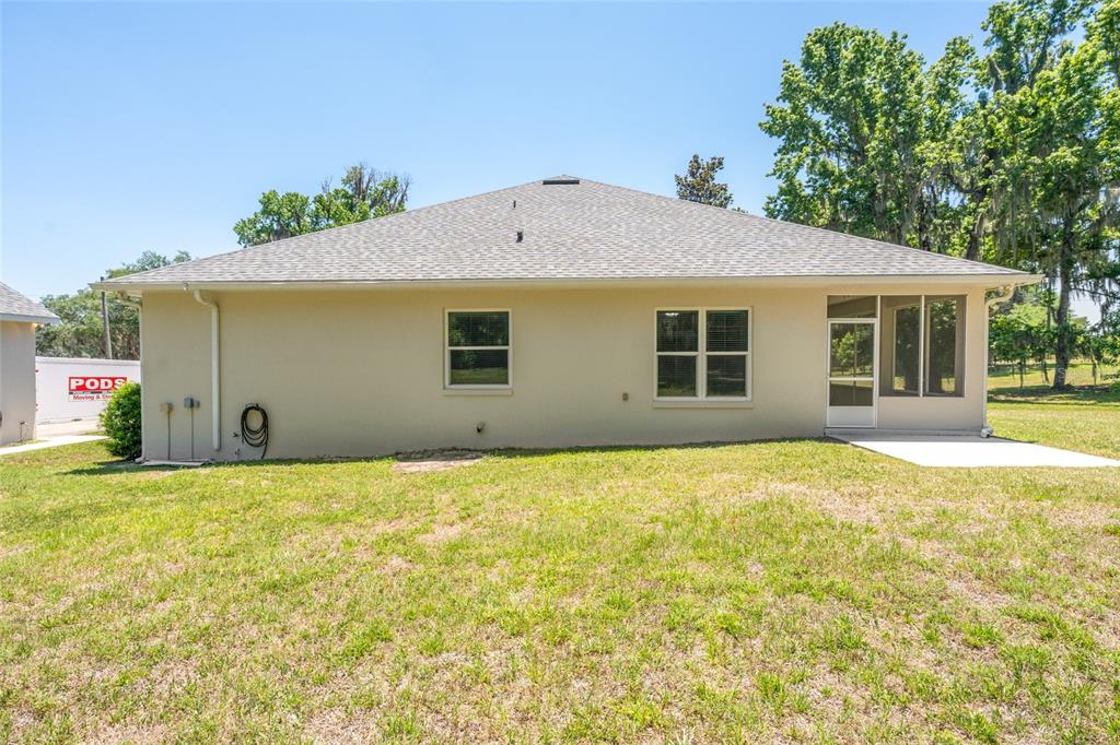 4735 Southeast 112th Street Road Belleview, FL 34420 - Photo 64 of 73 a house with trees in front of it