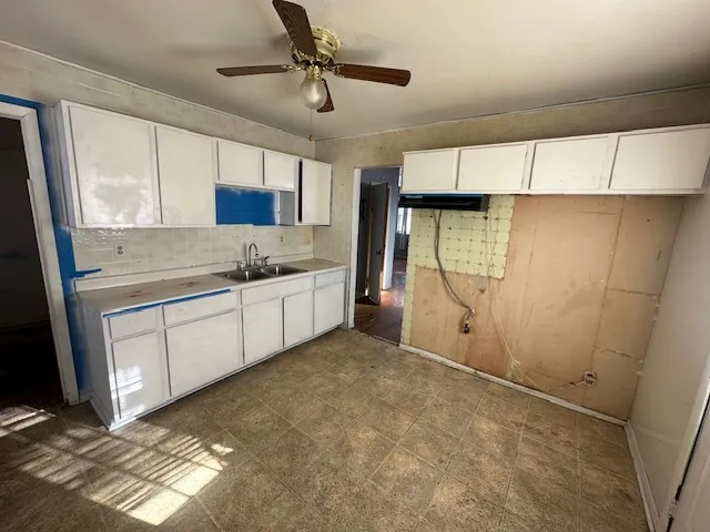 a kitchen with a sink and cabinets