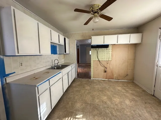 a view of a kitchen with a sink and cabinets