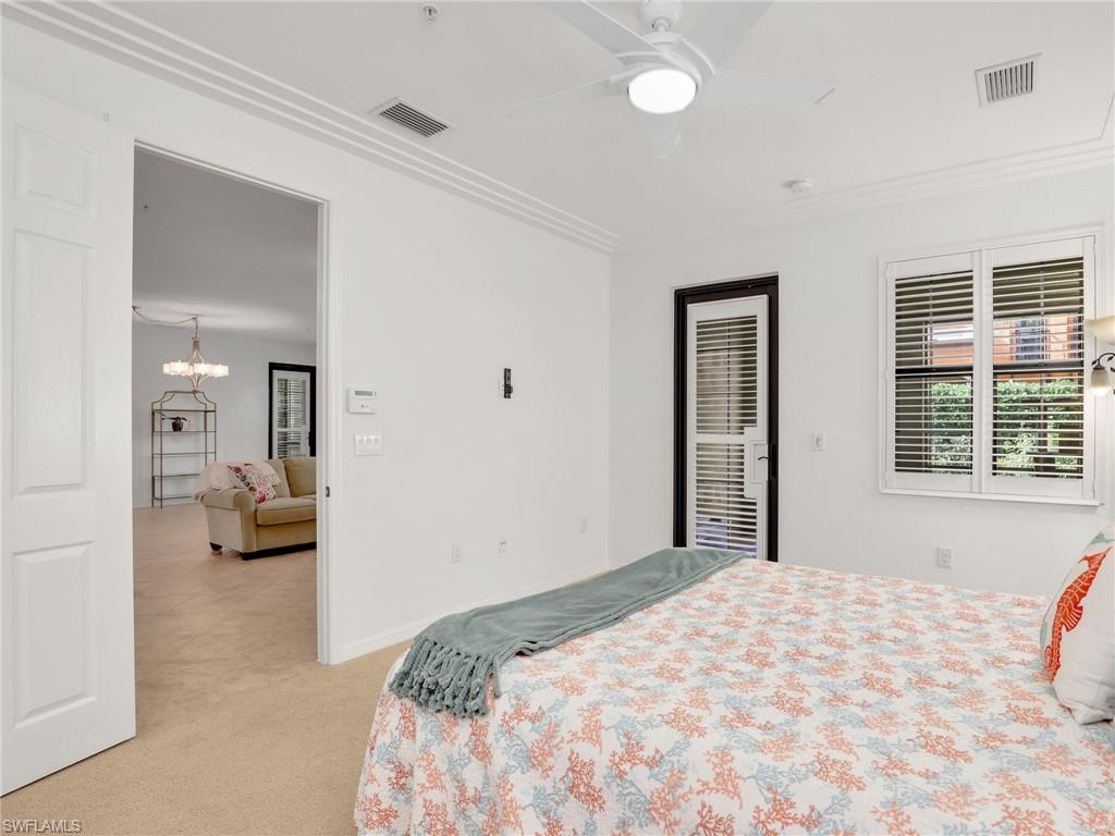 9066 Albion Lane North, Unit 5103 Naples, FL 34113 - Photo 18 of 40 a bedroom with a bed and a large window