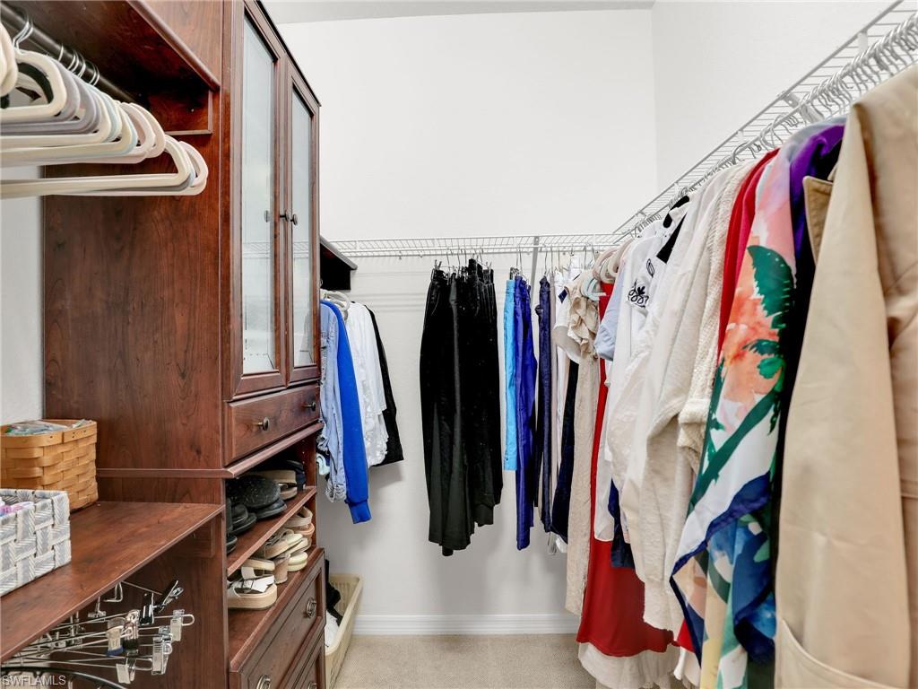 9066 Albion Lane North, Unit 5103 Naples, FL 34113 - Photo 20 of 40 a view of walk in closet with clothes and shoes