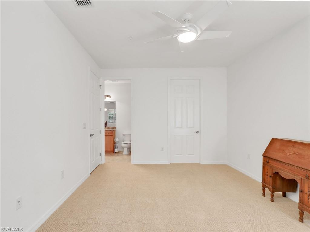 9066 Albion Lane North, Unit 5103 Naples, FL 34113 - Photo 23 of 40 an empty room with closet and a chandelier fan