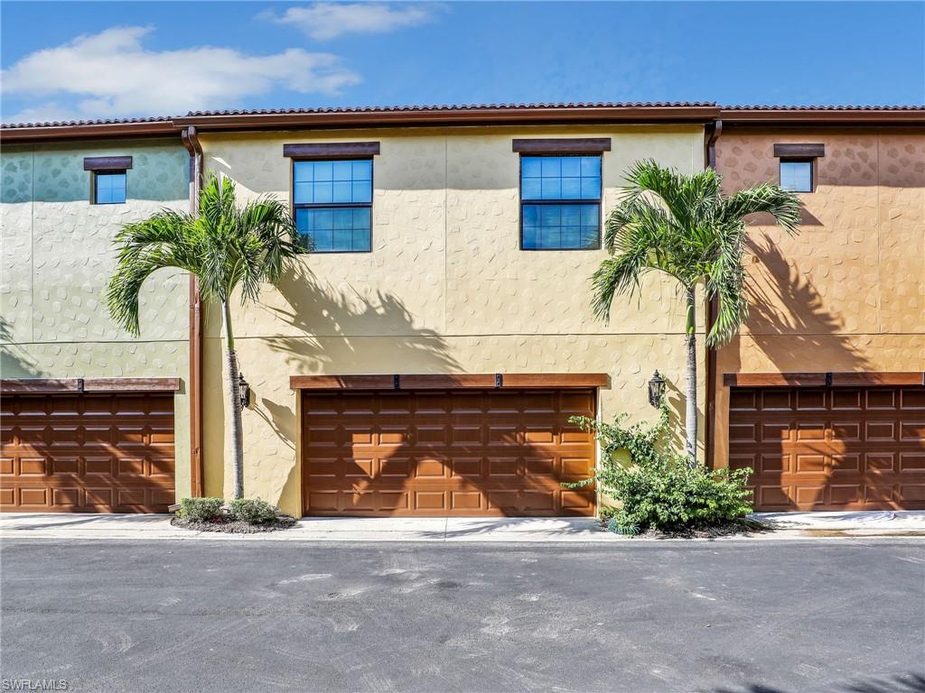 9066 Albion Lane North, Unit 5103 Naples, FL 34113 - Photo 28 of 40 a front view of a house with a yard and garage