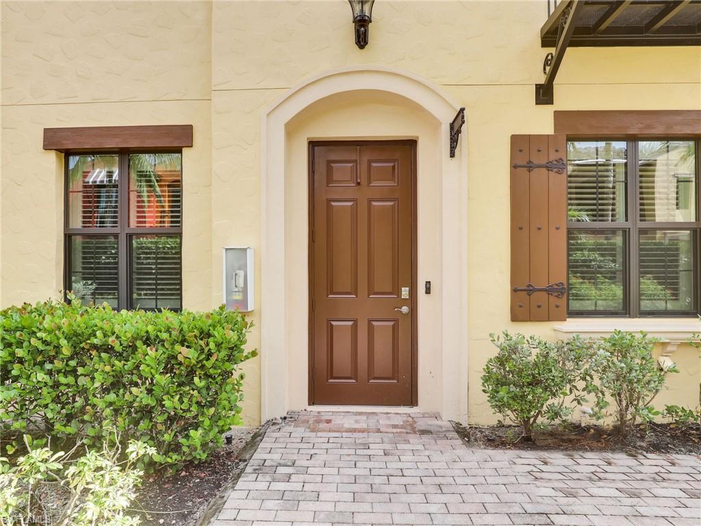 9066 Albion Lane North, Unit 5103 Naples, FL 34113 - Photo 3 of 40 a front view of a house with a yard