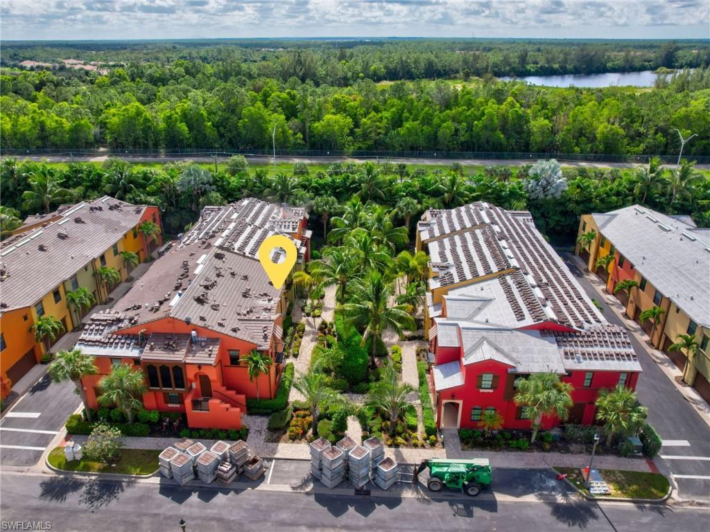 9066 Albion Lane North, Unit 5103 Naples, FL 34113 - Photo 39 of 40 an aerial view of a house with a garden and a yard