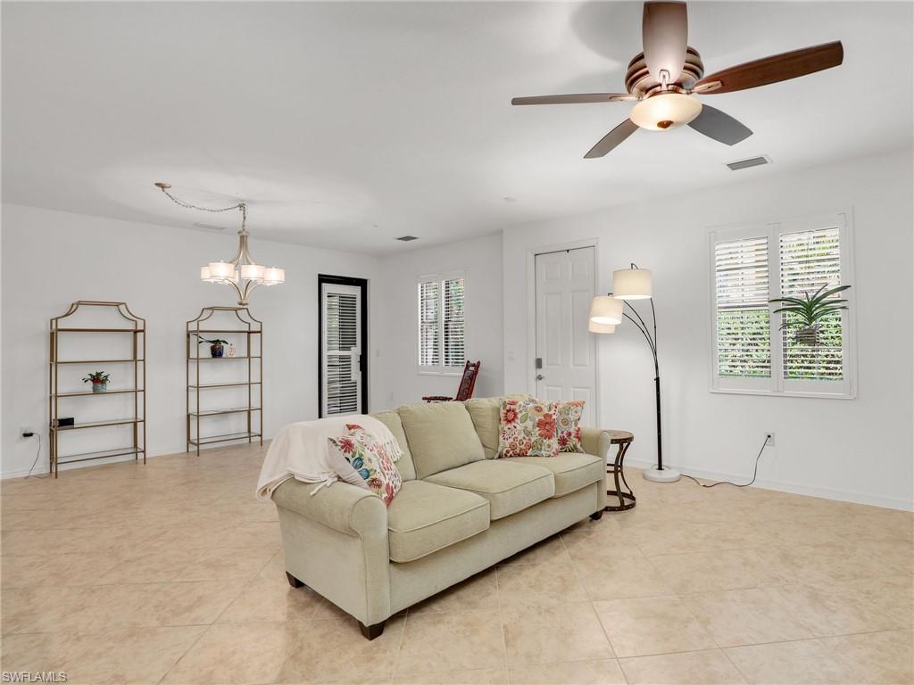 9066 Albion Lane North, Unit 5103 Naples, FL 34113 - Photo 8 of 40 a living room with furniture and a chandelier