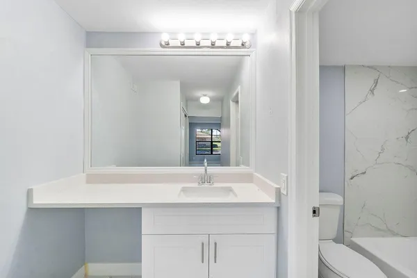 a bathroom with a bathtub and a sink