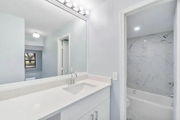 a bathroom with a bathtub and a toilet