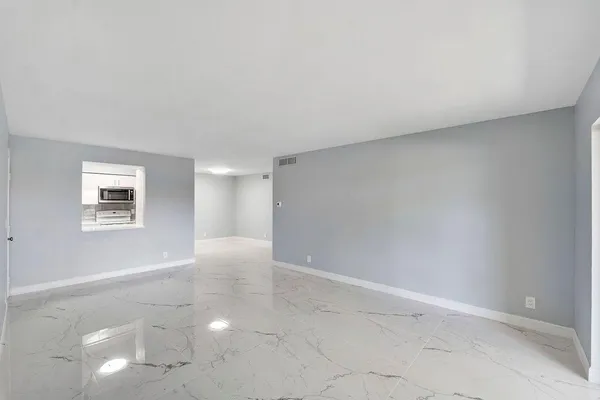 en empty room with windows and entrance