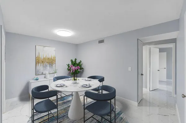 a view of a dining room that has a table and chairs in it