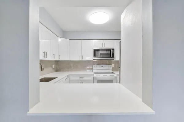 a kitchen with a sink cabinets and stainless steel appliances