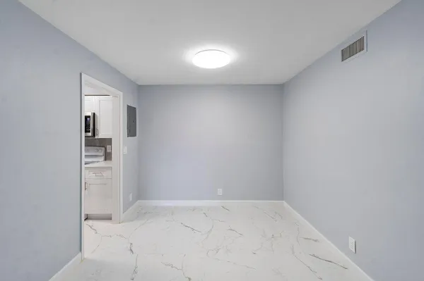 a view of a kitchen cabinets and a refrigerator in a kitchen