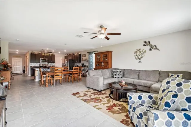 a living room with furniture and view of kitchen