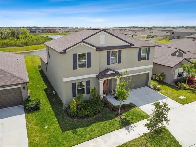 a aerial view of a house with a yard