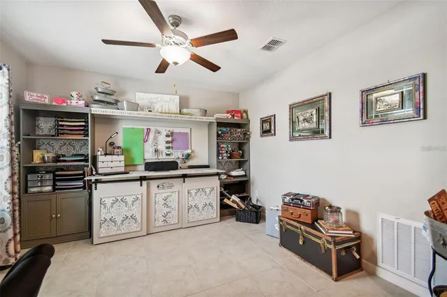 a living room with stainless steel appliances furniture and a kitchen view
