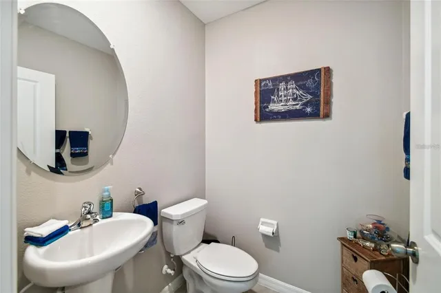 a bathroom with a toilet a sink and a mirror