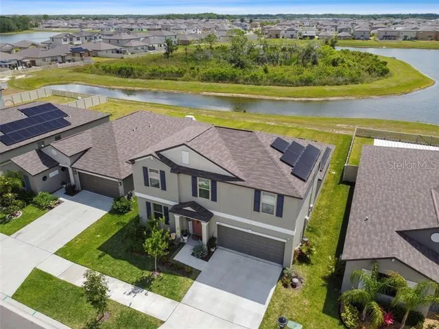 an aerial view of a house with a swimming pool