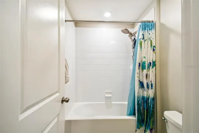 a bathroom with a shower and a tub