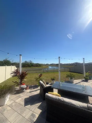 a view of a lake with couches in patio