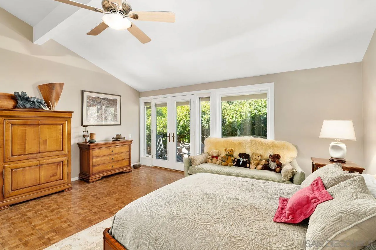 2224 Caminito Cabala La Jolla, CA 92037 - Photo 19 of 36 a bedroom with a bed and wooden floor